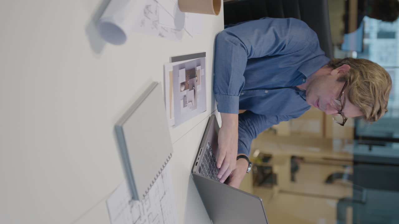 Mid-Aged Architect Typing on Laptop at Work in the Office