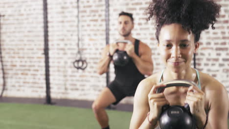 two-people-using-kettle-bells--while-working-out