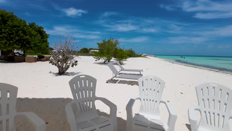 Outdoor-umbrella-and-chairs,-Cozy-vibe-home-front-caribbean-beach,-Madrisqui-island