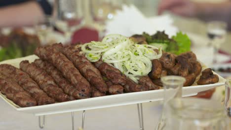 dinner table served with lula kebabs and fresh vegetables