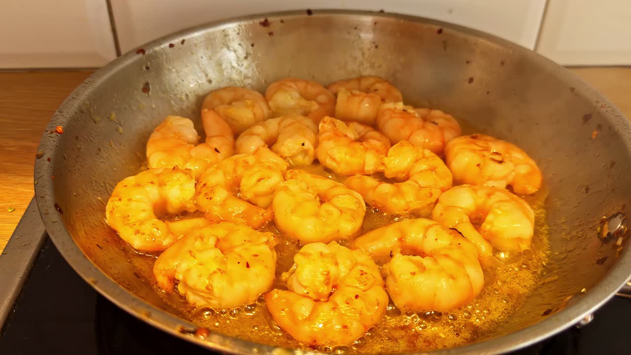 Shrimp being cooked in a pan curry sauce Asian cuisine home cooking seasoning dish