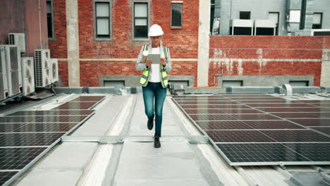 engineer inspecting solar panels on building rooftop