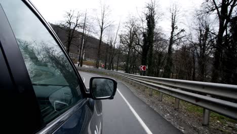 driving through the mountains on a winding road