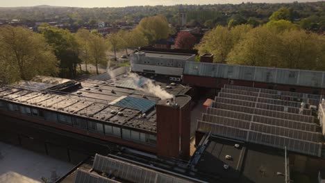 drone shot of industrial heating chimney steam