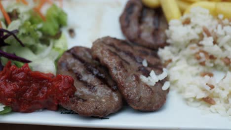 turkish kofte meal with rice, salad, and fries