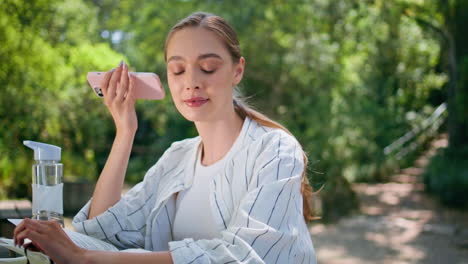 beautiful woman listening voice message relaxing at park with notepad close up.