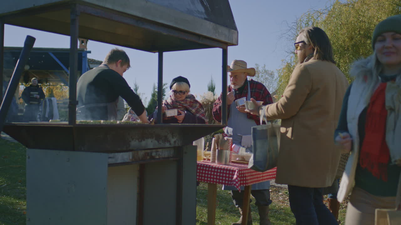Group of People are Trying Prepared on Campfire Meat at Night Group of People are Trying Prepared on Campfire Meat at Night