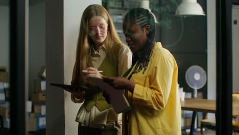 two women collaborating in a modern office