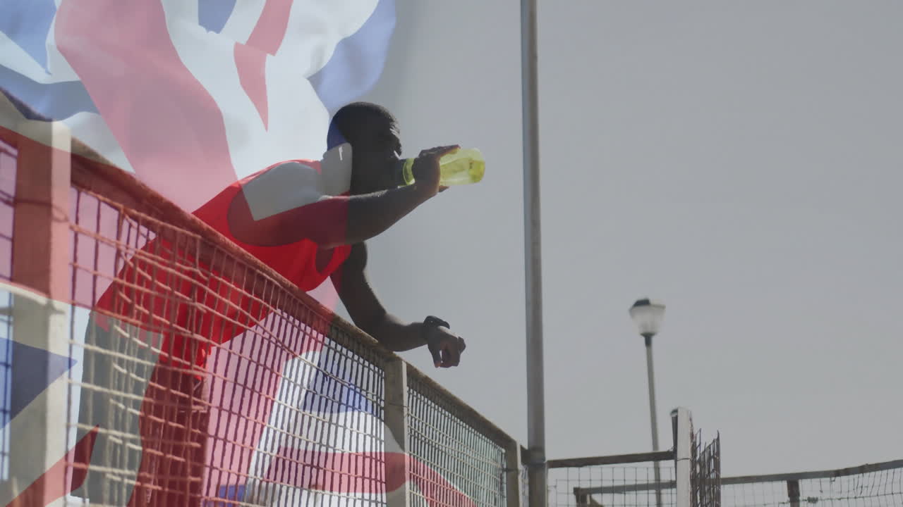 Drinking from bottle, athlete with British flag near sports field animation
