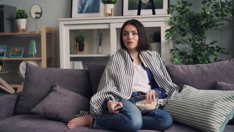 woman watching movie on couch