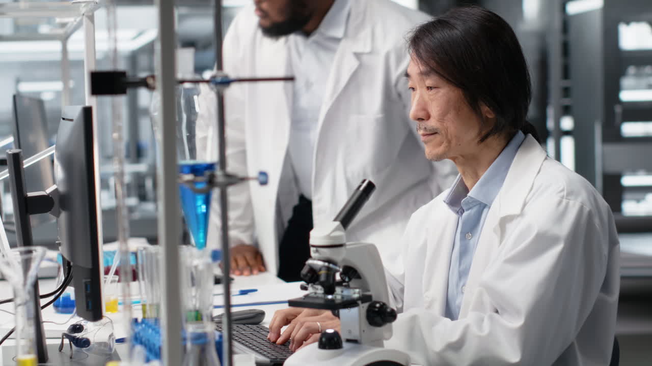 Vertical video Microscopist uses compound microscope to study genetic material