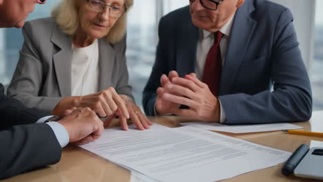 business professionals reviewing a document or contract at a meeting