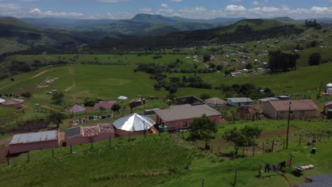 drone shot of the transkei in south africa - drone is flying over some traditional houses