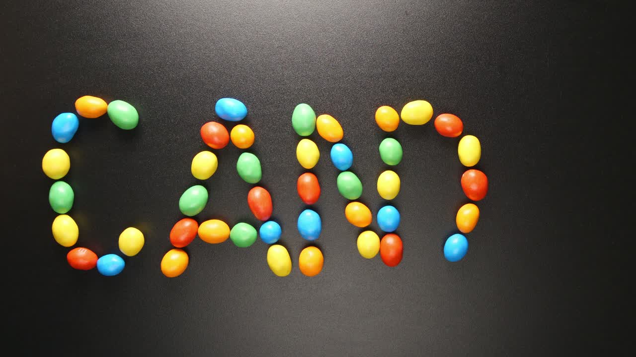 위쪽 보기: 다채로운 사탕에 의해 쓰여진 사탕 글자 (스 모션)