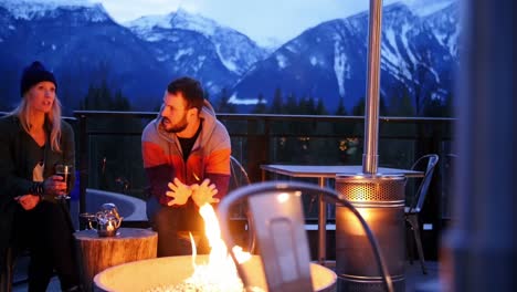 couple interacting nearby campfire