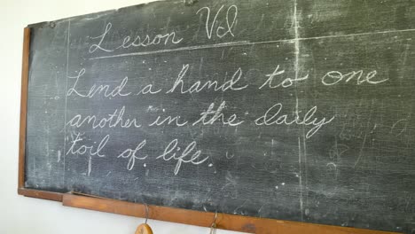 old chalkboard with old school lesson in one room schoolhouse