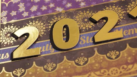 golden 2021 scrapbook notebook close-up, panning left to right