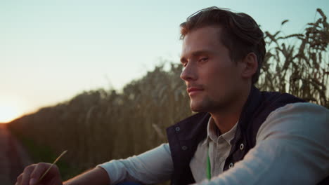 portrait farmer owner looking in camera. confident agrarian rest at sunset.