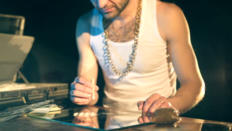 drug business. man holding a folded bill for sniffing and snorting the line.