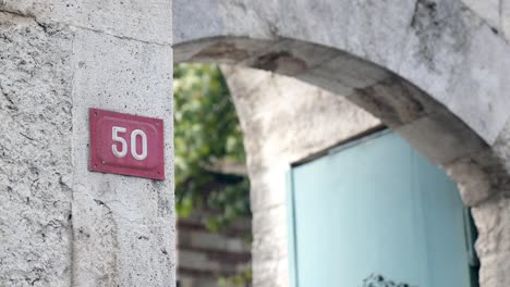 number 50 on a stone wall