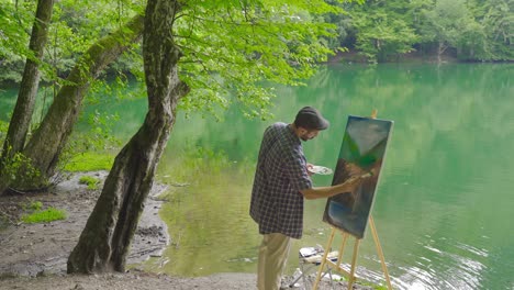 painter painting in the forest.