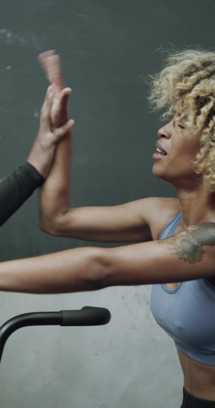 Personal Trainer Encouraging Woman During Intense Workout