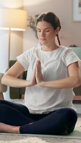 pregnant woman practicing yoga meditation at home