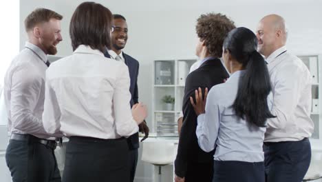 office workers playing trust game and laughing