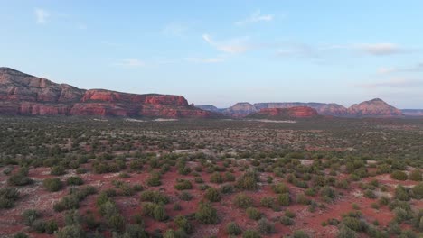 drone fly over wild bushes on the red rugged sandstone mountains in sedona, arizona