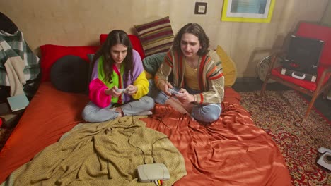couple gaming on a bed