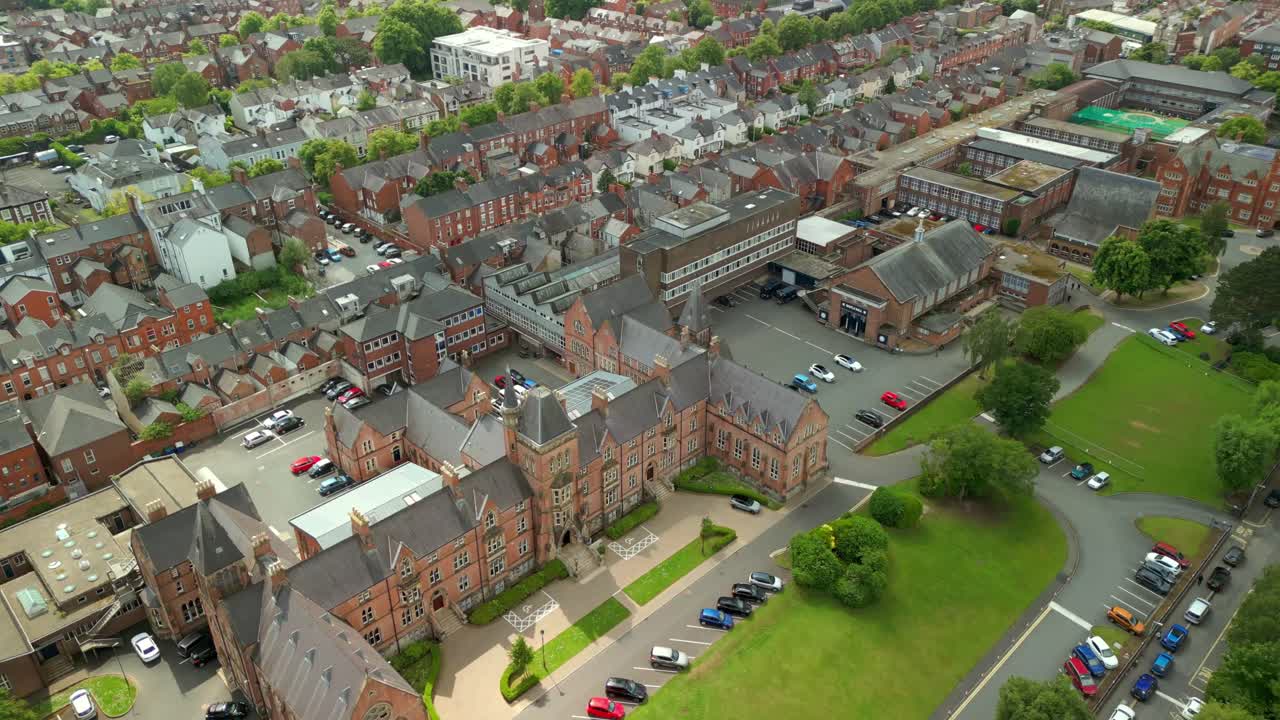 Wide overhead aerial video of Methodist College Belfast, in Northern Ireland, UK on a bright and sunny day. Filmed in 4K, 60FPS and with Rec709 color.