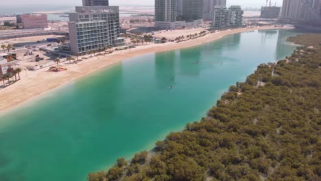 aerial flying over mangroves and al reems recreational space with kayakers