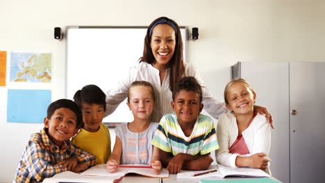 Portrait-of-teacher-and-school-kids-in-classroom