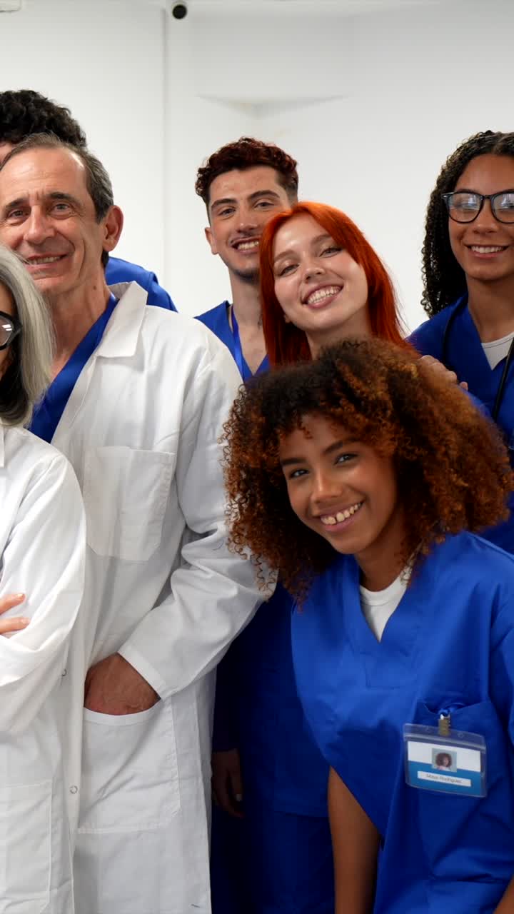 Grupo diverso de profissionais médicos sorridentes posando em um hospital.
