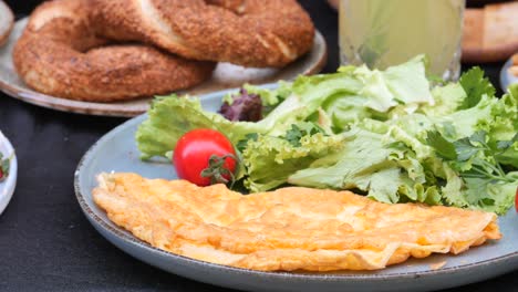 delicious turkish breakfast with omelette, tomatoes, lettuce, and bread