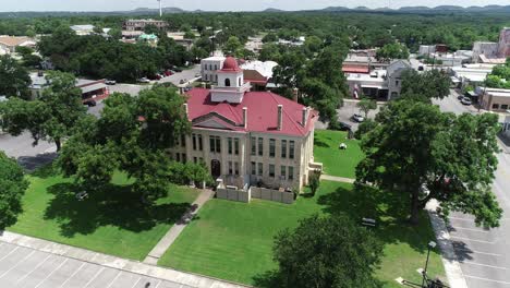 this is a aerial video of johnson city in texas. lowering in front of the courthouse.