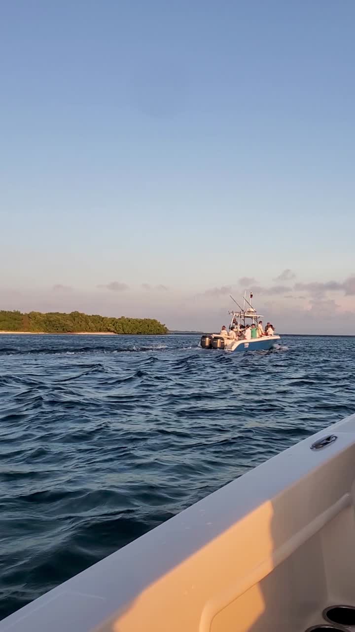 POV watching sport boat sailing with tourist on caribbean sea sunset time, Los Roques