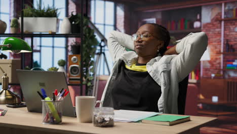 woman watching movies at home on laptop, drinking coffee