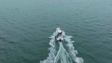 aerial tracking shot of a scientific boat sailing to the location at sete