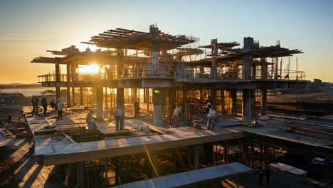 workers construct a modern building at sunset in tranquility
