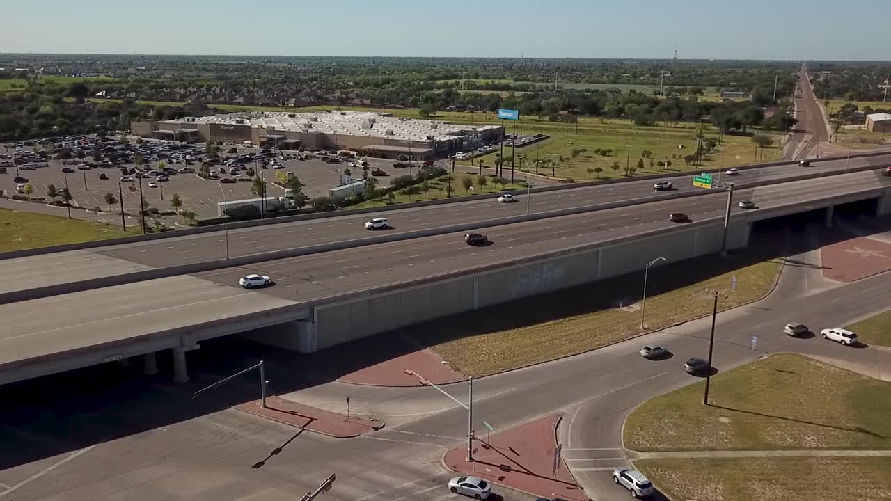 Drone footage of a freeway in Edinburg, Texas area on a morning with light vehicular traffic