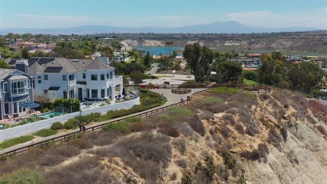 aerial flyover of a walking trail and housing in newport beach, california