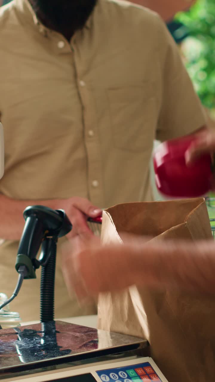 Vertical video Storekeeper serving client with produce