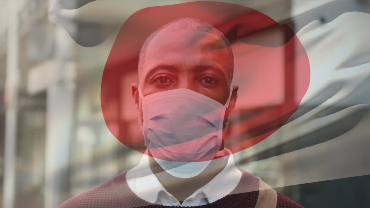 도시 거리에서 얼굴 마스크를 쓰고 있는 아프리카계 미국인 남성 위에 흔들리는 일본 국기의 애니메이션