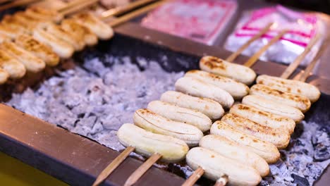 bananas grilling over coals at floating market