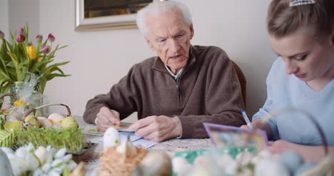 happy easter grandfather and granddaughter writing easter cards with greetings 6