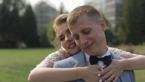 newlyweds. caucasian groom with bride in the park. wedding couple. happy family