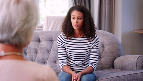 depressed young woman having therapy with a psychologist