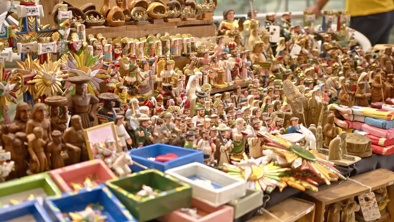 Exhibition in a market in Paraguay of various saints figures from the Christian faith, handcrafted from wood with detailed craftsmanship and high quality