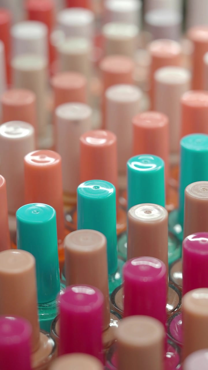 Rows of Vibrant Nail Polish Bottles with Colorful Caps
